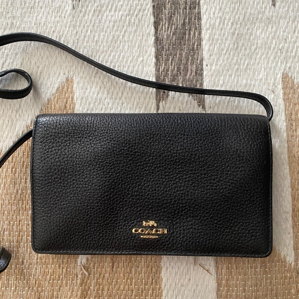 black leather Coach wallet with strap